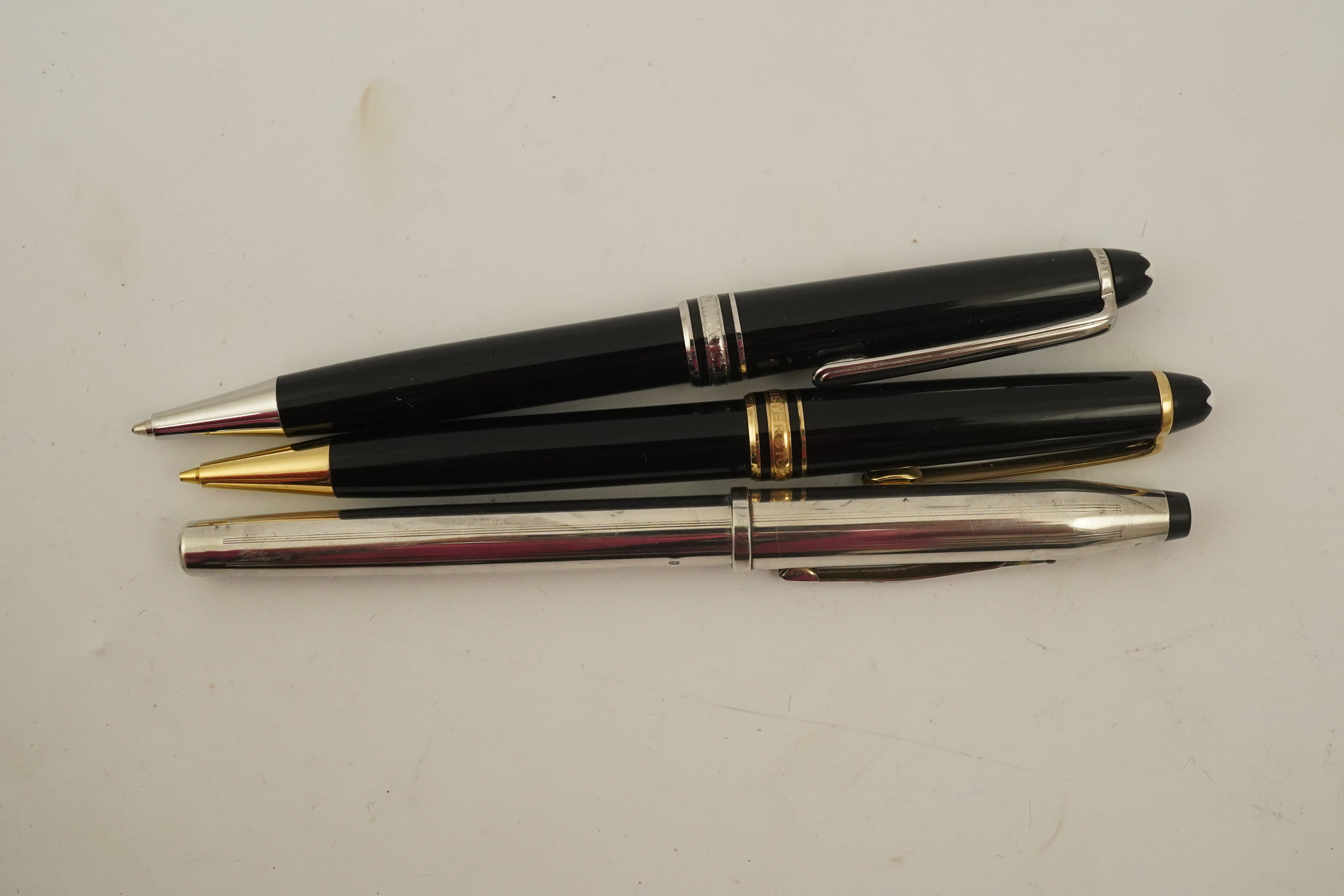 A Montblanc ballpoint pen, a Montblanc pencil and a Cross fountain pen